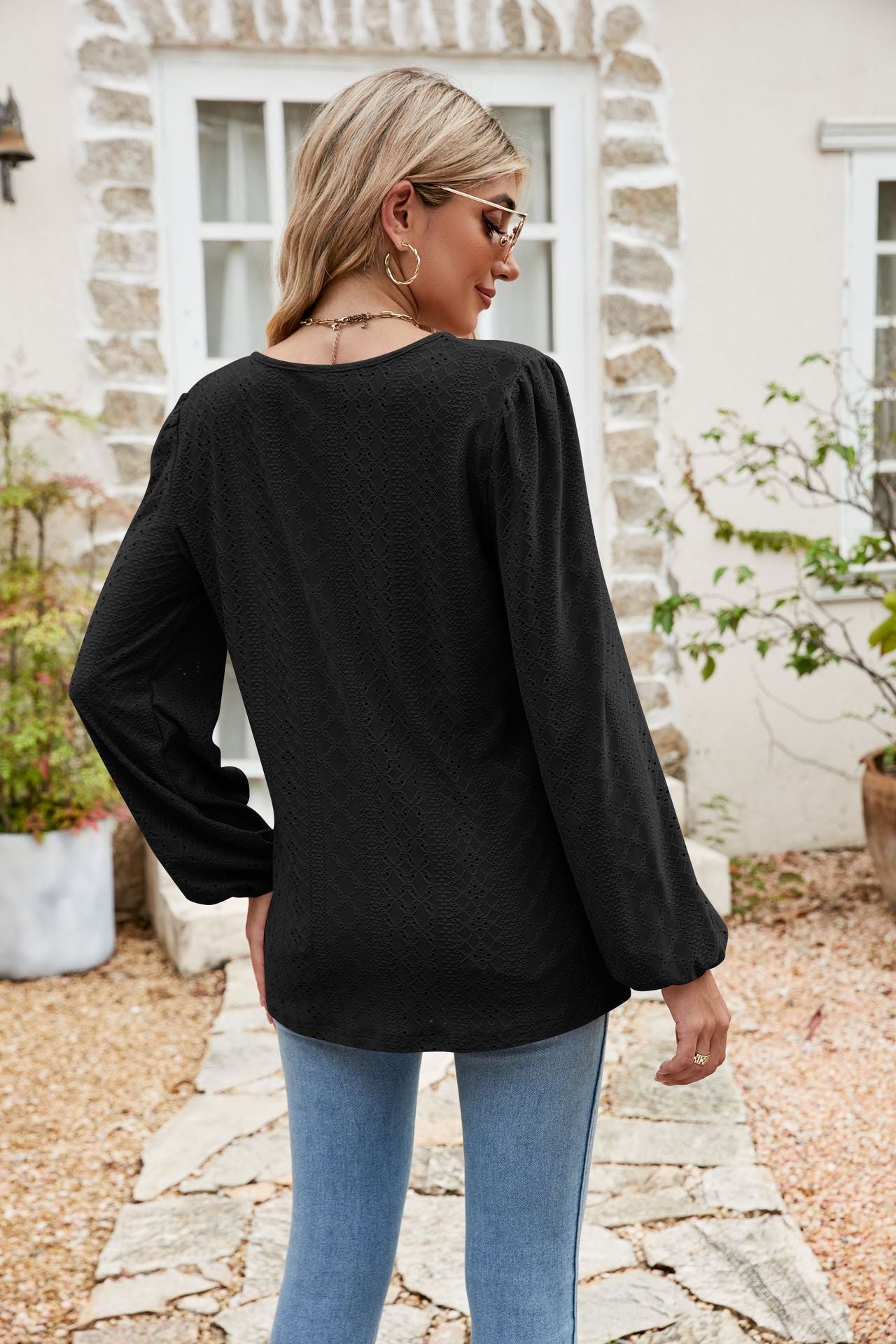 Black eyelet yoke blouson sleeve top with textured pattern