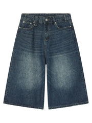 Light blue denim culottes with distressed details and wide legs.