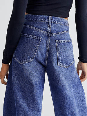Medium wash denim palazzo jeans with frayed hem detail, shown from the back.