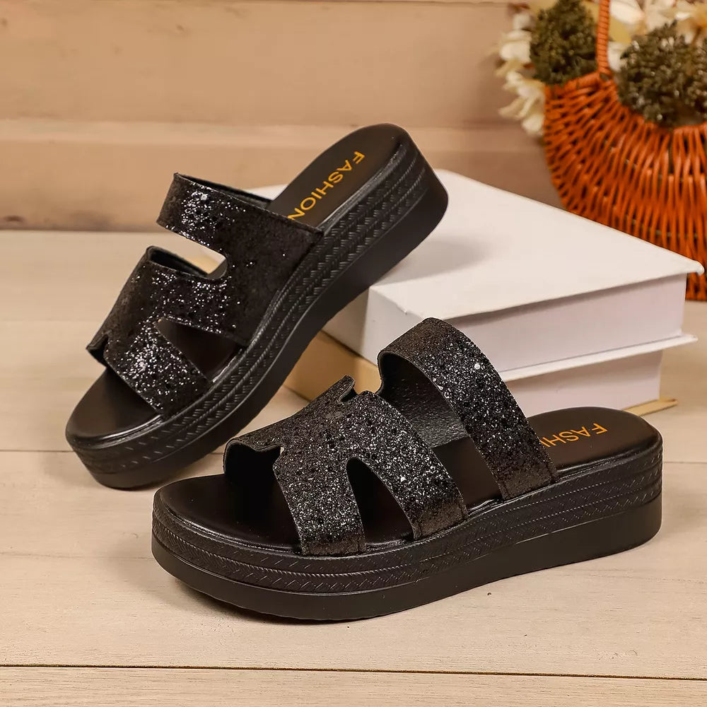 Black glitter platform sandals with open toe and double strap detail.