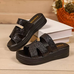 Black glitter platform sandals with open toe and double strap detail.