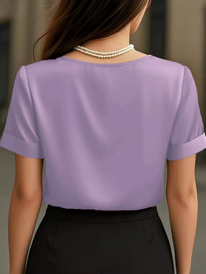 Light Purple satin shirt with cuffed sleeves and V-neck, styled with a pearl necklace.