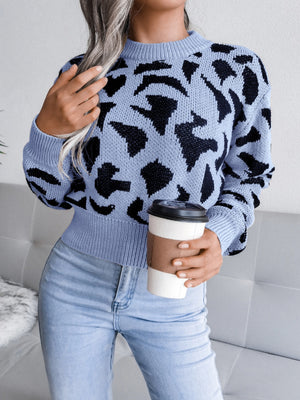 Pastel blue abstract knit cropped sweater with mock neck and long sleeves.