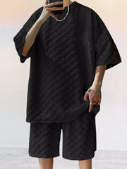 Black textured casual two-piece set for men with short sleeves and shorts.
