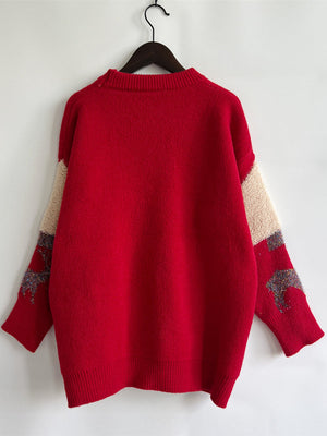 Red acrylic sweater with sequin-trimmed Christmas tree detail on sleeves and tan colorblock.