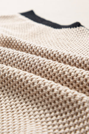 Beige knit top with black trim detail and cap sleeves.