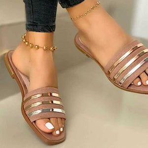 Beige open-toe flat sandals with metallic stripe detail and gold anklet