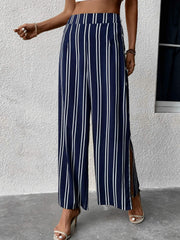 Dark blue vertical stripe palazzo trousers with slit legs and button detail.