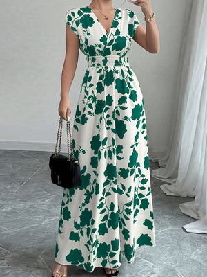 Floral maxi dress with surplice neckline, cap sleeves, and smocked waist in dark green and white.