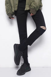 Distressed knee skinny jeans in dark cotton with a ripped detail on the left knee.