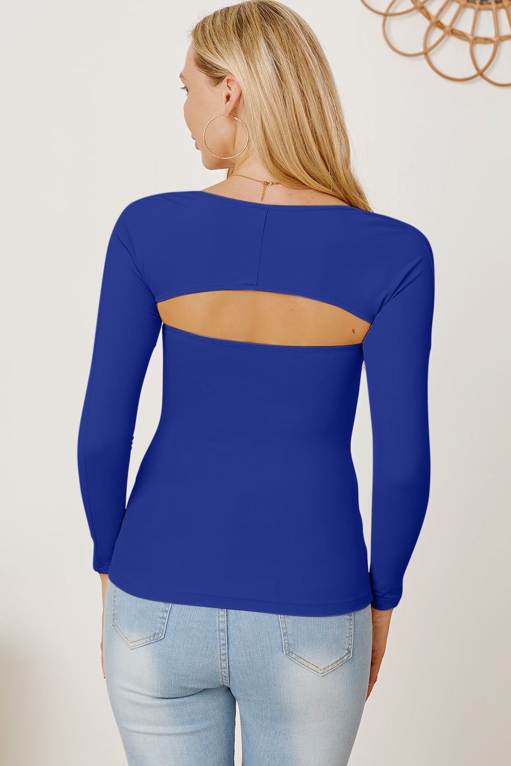 Royal blue long sleeve bodysuit with open back detail.