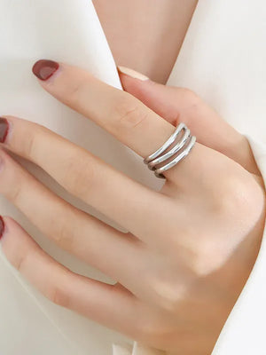 Silver triple-band sculptural ring with smooth finish.