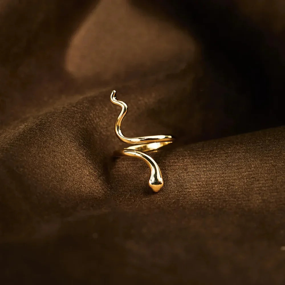 Gold finish serpentine coil ring with sculptural snake design