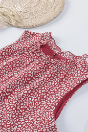 Burgundy printed sleeveless blouse with ruffled neckline detail.