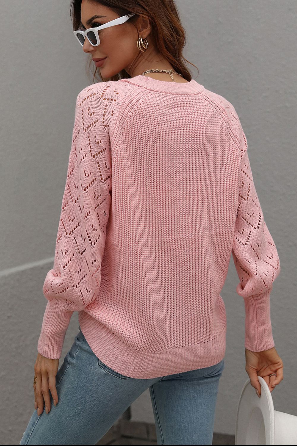 Pink acrylic diamond knit cardigan with openwork sleeves and crew neck.