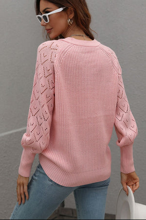 Pink acrylic diamond knit cardigan with openwork sleeves and crew neck.