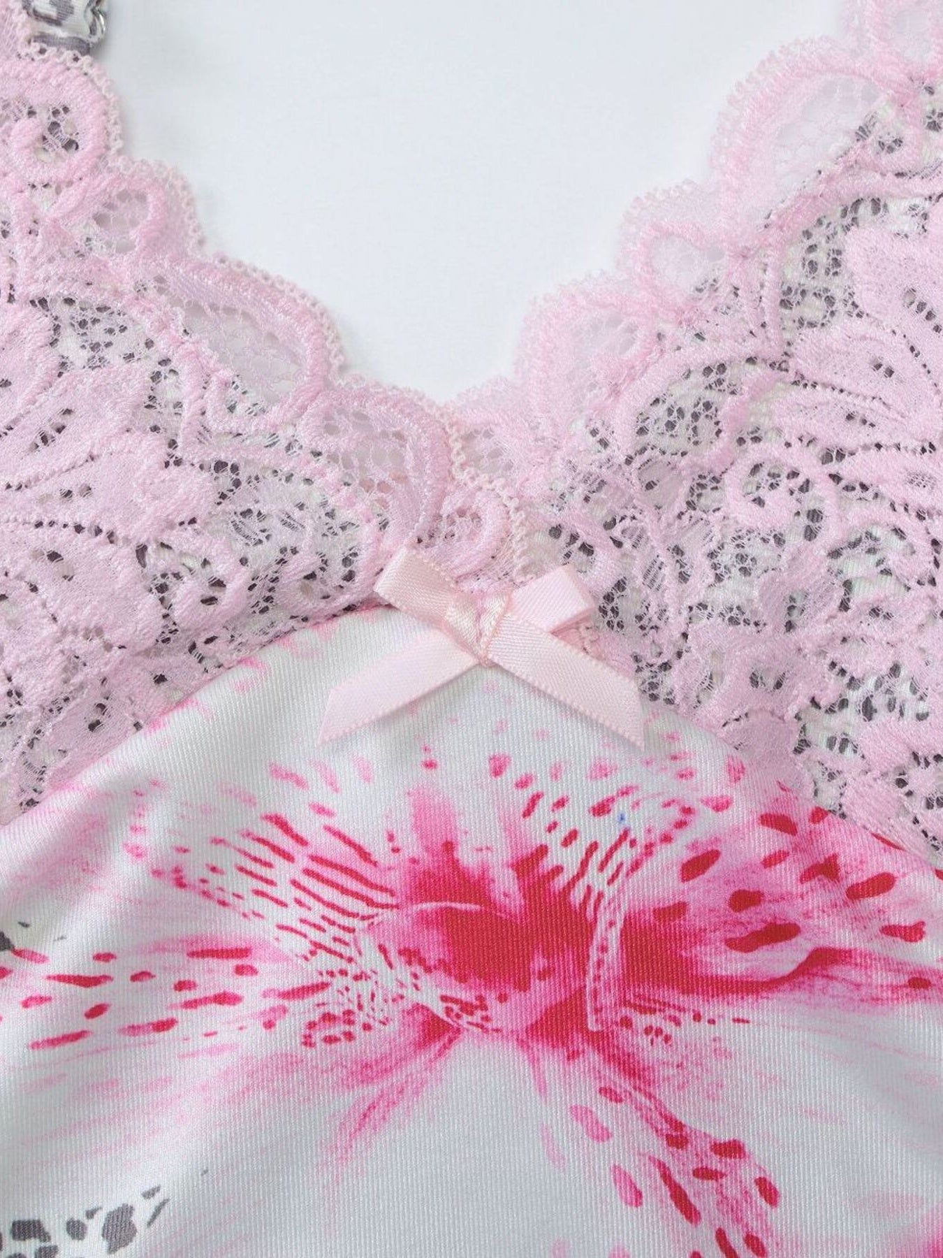 Lace-trimmed camisole with pink floral print and bow detail