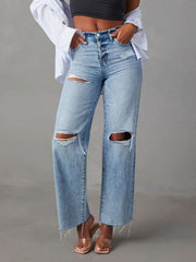 Light wash denim wide leg jeans with distressed knee rips and frayed hem