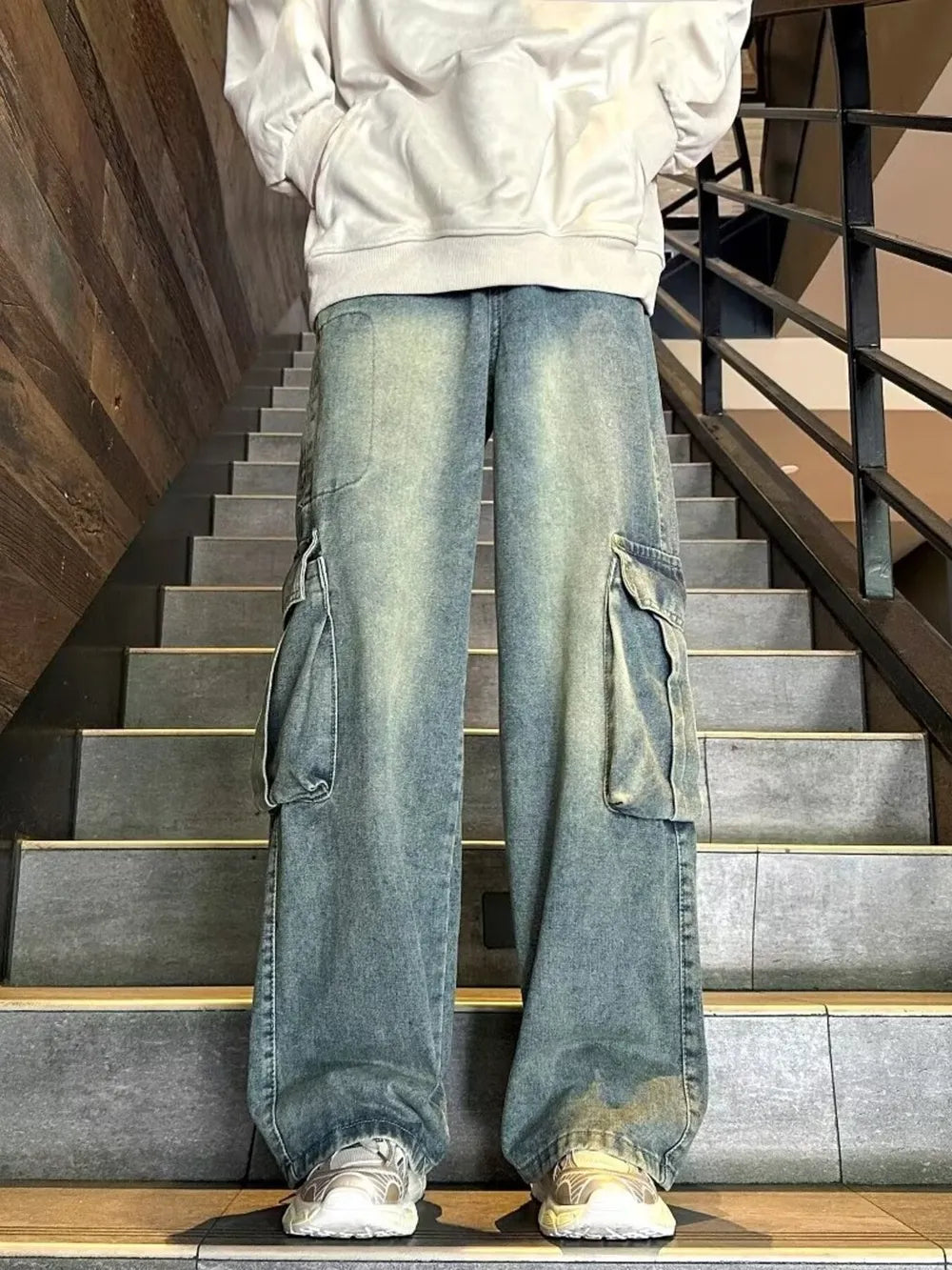 Men's vintage-inspired wide-leg blue denim cargo pants with distressed details.