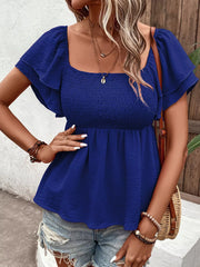Blue textured smocked blouse with square neckline and ruffled short sleeves.