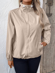 Nylon bomber jacket in beige with drawstring hem and zip front.