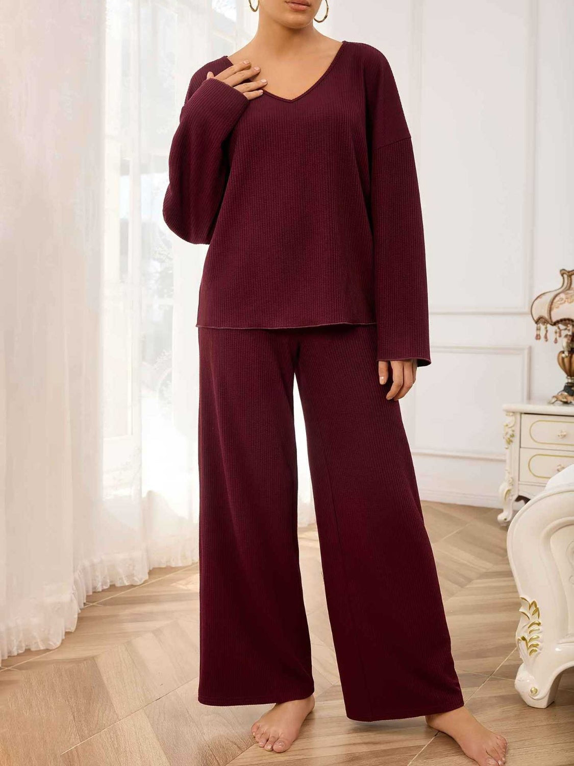 Burgundy textured loungewear set with wide-leg pants and a v-neck top.