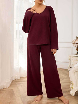 Burgundy textured loungewear set with wide-leg pants and a v-neck top.
