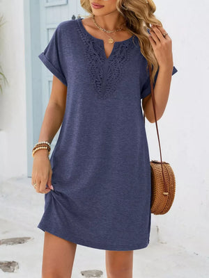 Dusty blue short sleeve dress with lace V-neck detail and cuffed sleeves.