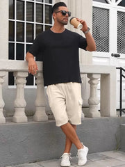 Khaki relaxed fit drawstring cargo shorts with utility pockets.