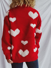 Red acrylic sweater with textured white heart appliqués, crew neck, long sleeves.
