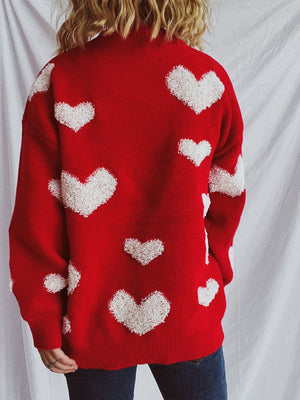 Red acrylic sweater with textured white heart appliqués, crew neck, long sleeves.