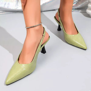 Green kitten heel slingback pumps with pointed toe and ankle strap.