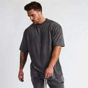 Oversized dark gray graphic tee with a washed-out look.