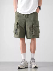 Green cargo shorts with multiple pockets and a lightweight feel.