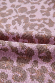 Knit fabric with a pink and brown leopard print pattern.