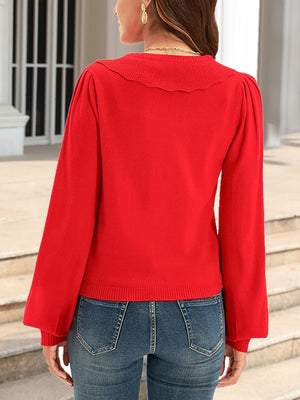 Red knit cardigan with scalloped collar and puff sleeves.