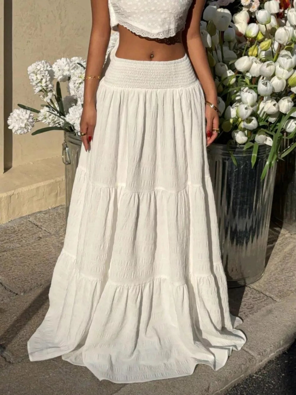 White tiered maxi skirt with smocked waist and crinkled texture