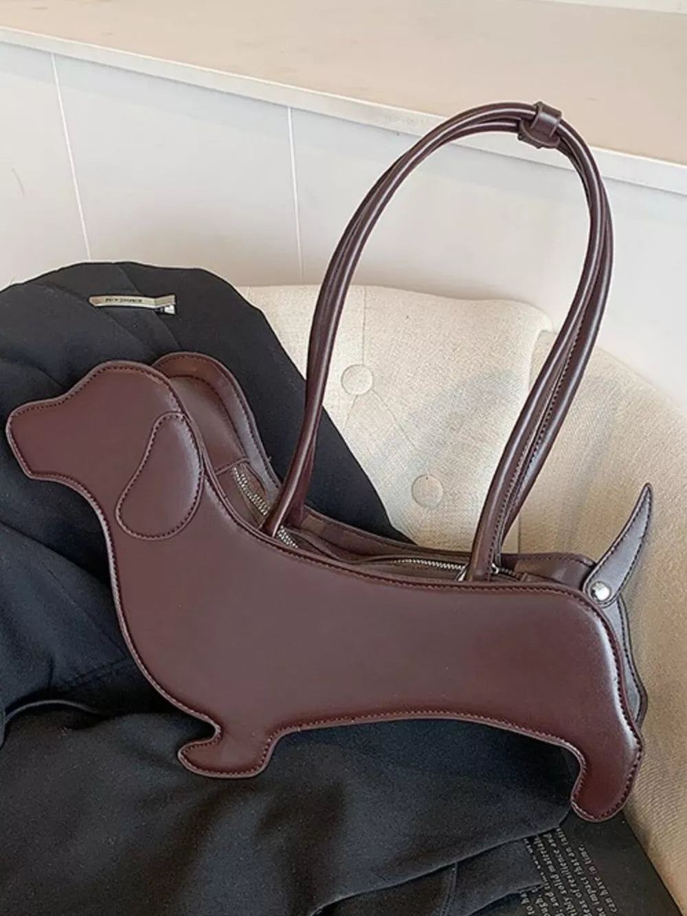 Charming dachshund shoulder bag in coffee color PU leather with top handles.