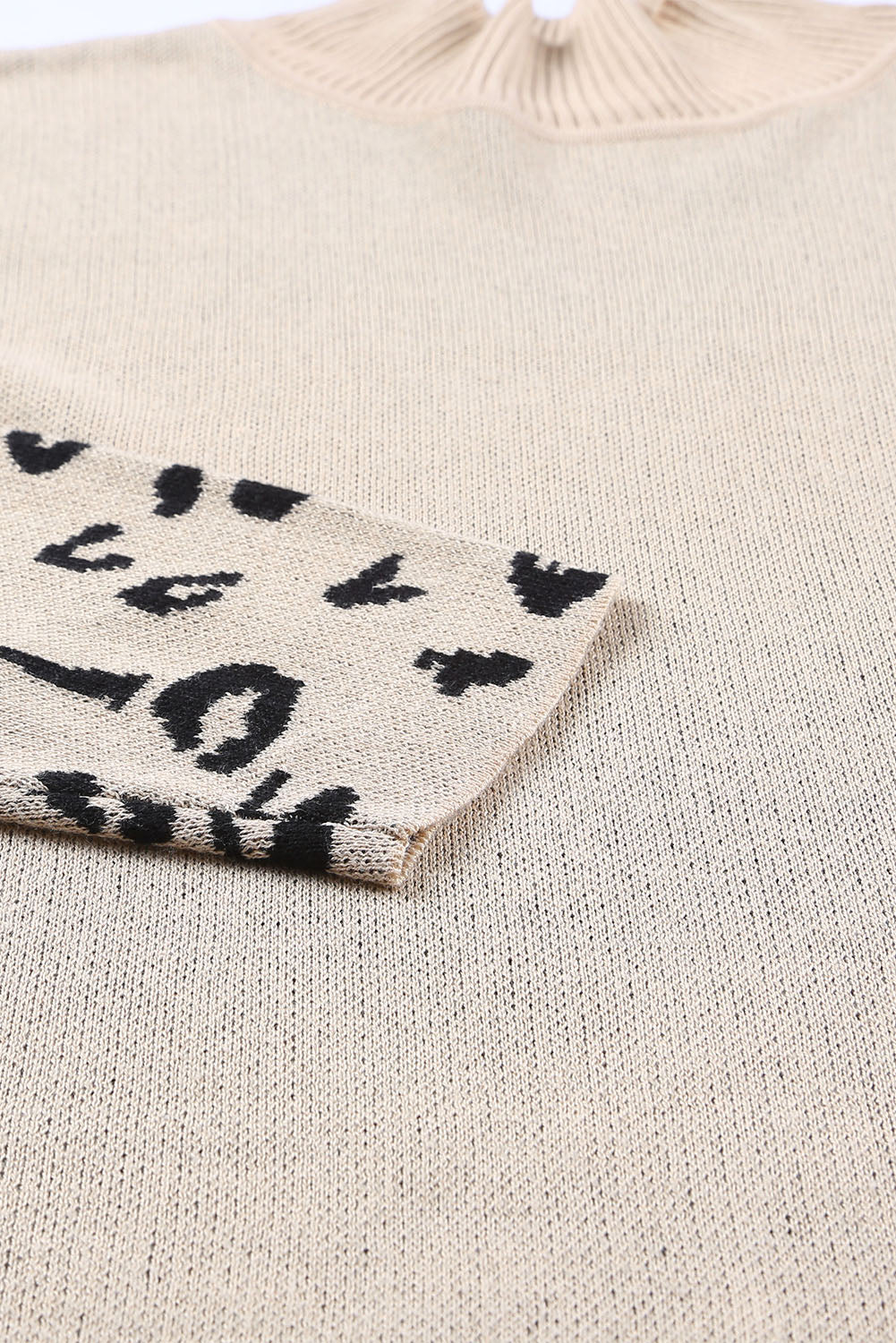 Khaki knit sweater with asymmetric black leopard print panel on sleeve.