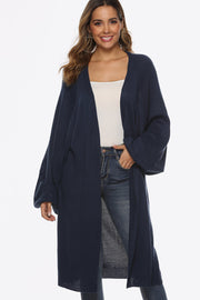Dark blue oversized sleeve maxi knit cardigan with an open front and ribbed cuffs.