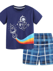 Navy cotton tee with astronaut and rocket graphic, paired with blue plaid shorts.