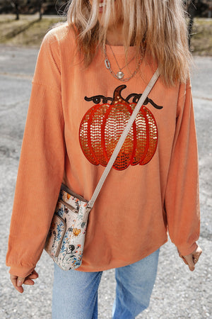Orange corduroy sweatshirt with sequin pumpkin graphic, relaxed fit, crew neck.