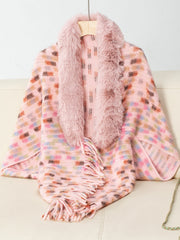 Pink textured plaid poncho with faux fur collar and fringe detail.