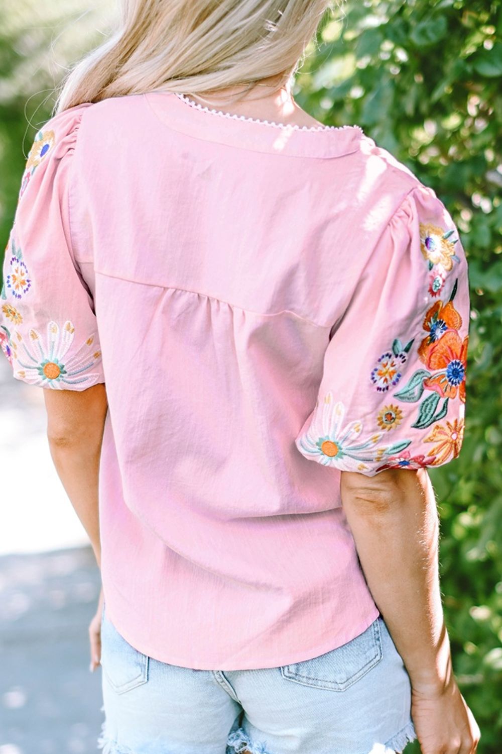 Dusty pink peasant blouse with embroidered floral puff sleeves and scalloped neckline.