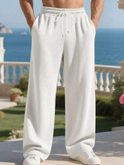 Men's white ribbed drawstring sweatpants with a relaxed fit and wide leg.