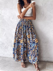 Bohemian print wide-leg pants with smocked waist in dark navy with floral pattern.