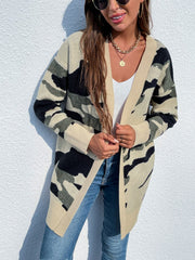 Longline knit cardigan in green camouflage pattern with beige trim and cuffs.