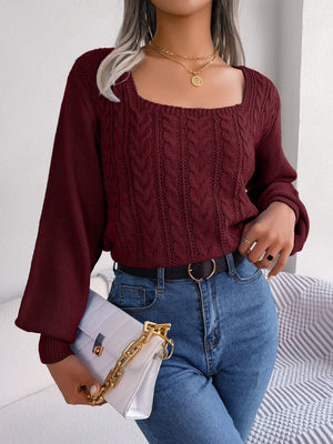 Wine cable knit sweater with square neckline and balloon sleeves, styled with jeans and a handbag.