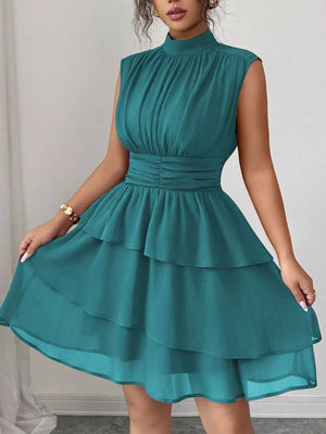 Sleeveless teal tiered ruffle dress with ruched bodice and mock neck.