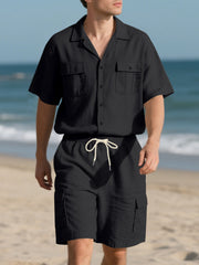 Black relaxed-fit button-up shirt with dual chest pockets and drawstring shorts.
